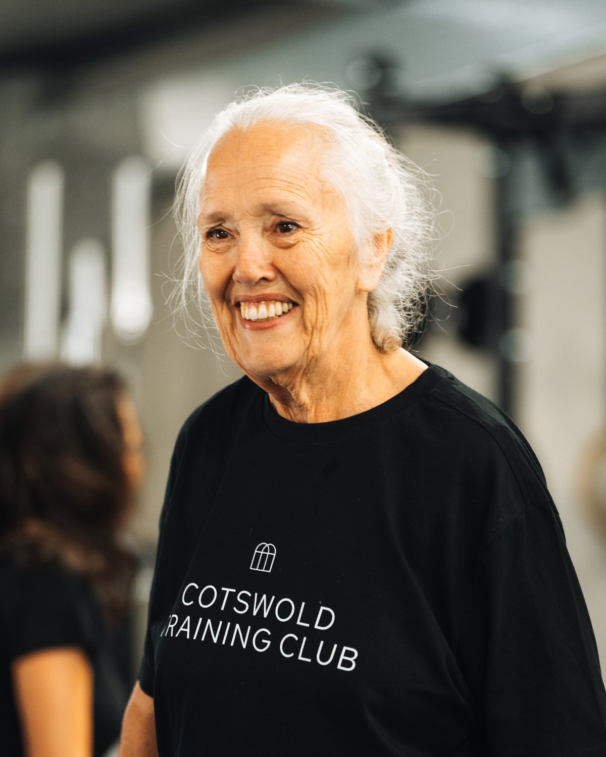 A Cotswold Training Club member, smiling, between sets